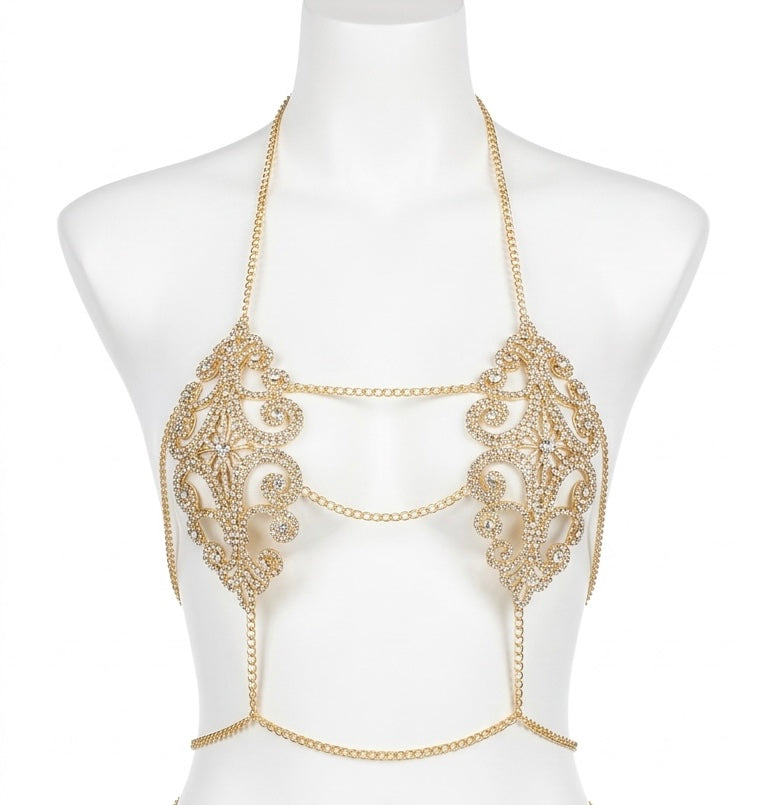 Gold chain and embellished top on a mannequin against a white background