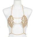Gold chain and embellished top on a mannequin against a white background